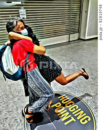 Color painting of two people hugging each other on a writing on the floor where it says hugging point 82819748