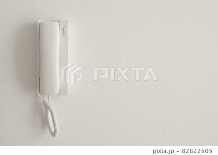 White telephone on a white wall. Copyspace. White telephone on a white wall. Copyspace. 82822505