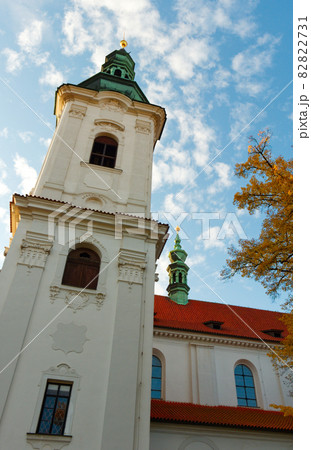The bell tower of the Strahov Monastery against the blue sky in autumn. 82822731
