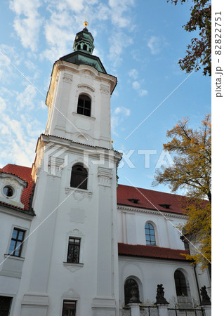 The bell tower of the Strahov Monastery against the blue sky in autumn. The bell tower of the Strahov Monastery against the blue sky in autumn. 82822751