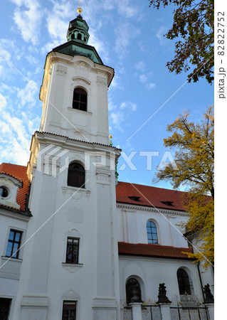 The bell tower of the Strahov Monastery against the blue sky in autumn. 82822752