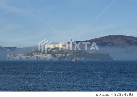 SAN FRANCISCO, CALIFORNIA, UNITED STATES - NOV 25th, 2018: Alcatraz prison in fog panorama during a sunny day in November as seen from pier 39 SAN FRANCISCO, CALIFORNIA, UNITED STATES - NOV 25th, 2018: Alcatraz prison in fog panorama during a sunny day in November as seen from pier 39 82824592