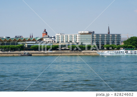 MAINZ, GERMANY - JUL 09th, 2017: Luxury Hilton Hotel next to the Rhine german Rhein. Outside view from the opposite river side. Hilton Hotels Resorts is an international chain of full service hotels 82824602