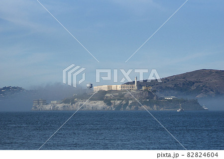 SAN FRANCISCO, CALIFORNIA, UNITED STATES - NOV 25th, 2018: Alcatraz prison in fog panorama during a sunny day in November as seen from pier 39 82824604