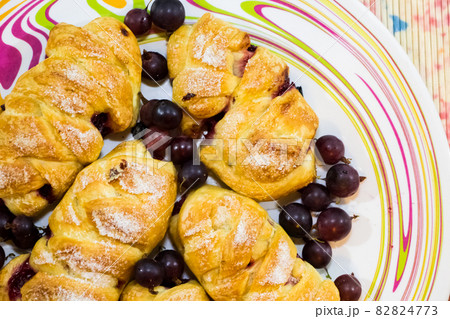 Croissants made of puff pastry stuffed with dark gooseberries 82824773