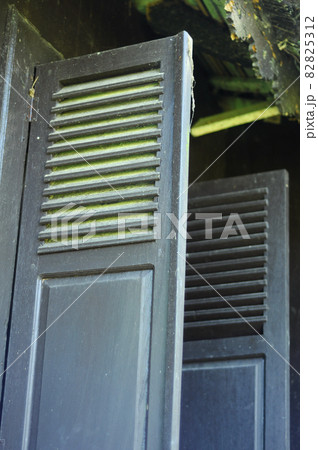 WEST SUMATERA, INDONESIA -JUNE 8, 2014: Traditional timber window at Tuo Kayu Jao Mosque in West Sumatra, Indonesia. Built in 1599 and is the second oldest mosque in Indonesia. WEST SUMATERA, INDONESIA -JUNE 8, 2014: Traditional timber window at Tuo Kayu Jao Mosque in West Sumatra, Indonesia. Built in 1599 and is the second oldest mosque in Indonesia. 82825312
