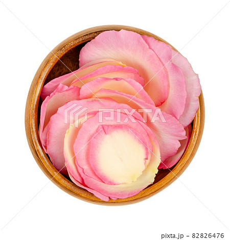Rose petals in a wooden bowl. Freshly picked petals of a light pink colored garden rose, called China, Chinese or Bengal rose. Rosa chinensis, ornamental plant, used for perfume, tea or as decoration. 82826476