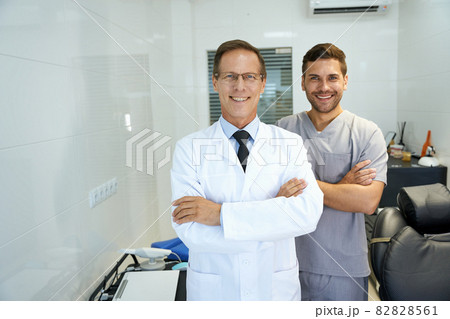 Two male dentists smiling and looking professional Two male dentists smiling and looking professional 82828561