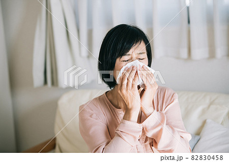 ティッシュで鼻をかむ女性・花粉症イメージ 82830458