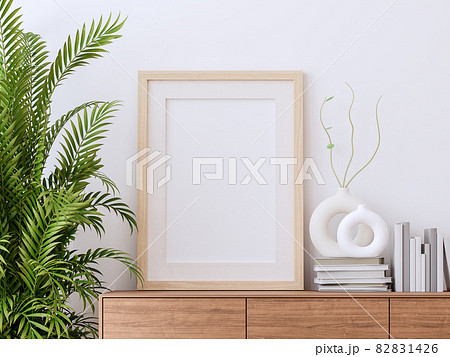 Blank picture frame on wooden cabinet with white wall background 3d render Blank picture frame on wooden cabinet with white wall background 3d render 82831426