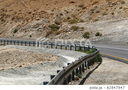 the road along the Dead Sea in southern Israel passes through the mountains and the desert 82847947
