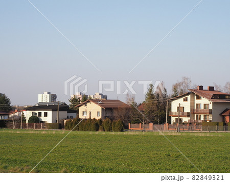 Green grassy field and houses in Bielsko-Biala city in Poland 82849321