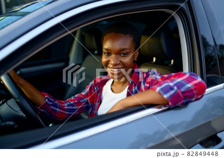 Woman poses in shinning car, auto wash station 82849448