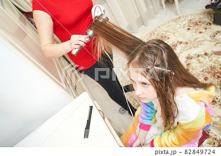 Mother dry daughter hair. Home activity. New normal. Barber equipment Mother dry daughter hair. Home activity. New normal. Barber equipment 82849724