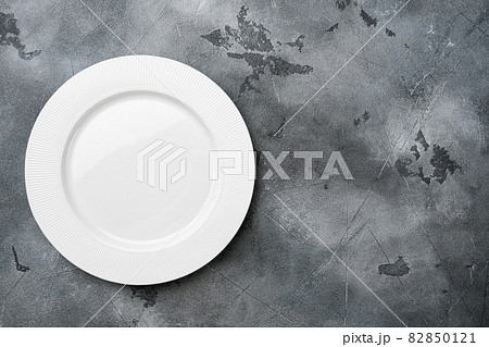 White plate empty utensil with copy space for text or food with copy space for text or food, top view flat lay , on gray stone table background White plate empty utensil with copy space for text or food with copy space for text or food, top view flat lay , on gray stone table background 82850121