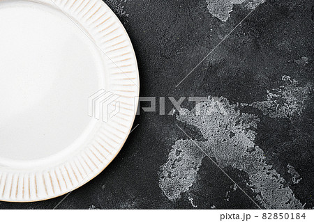 White plate empty utensil with copy space for text or food with copy space for text or food, top view flat lay , on black dark stone table background White plate empty utensil with copy space for text or food with copy space for text or food, top view flat lay , on black dark stone table background 82850184