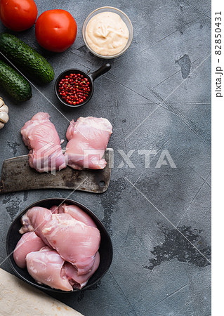 Raw gyros ingredients, chicken thighs on grey background, flat lay with copy space Raw gyros ingredients, chicken thighs on grey background, flat lay with copy space 82850431