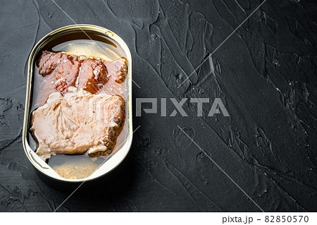 Wild Alaska Salmon Canned smoked fish, in tin can, on black background, with copyspace and space for text 82850570