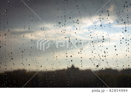 A raindrops on glass on the city background 82854994