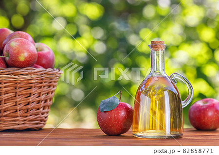 apple vinegar or cider in glass bottle outdoors 82858771