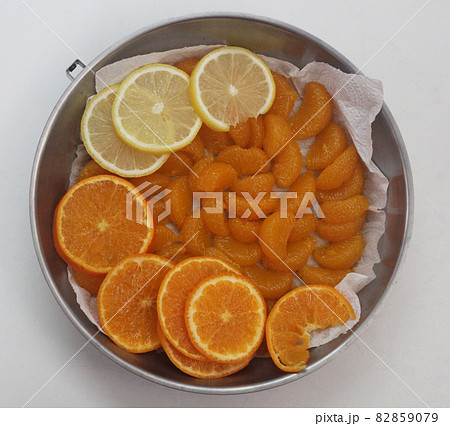 High angle view of organic freshness slide lemon and orange on stainless plate at home kitchen, fruit advserting backgrounds 82859079