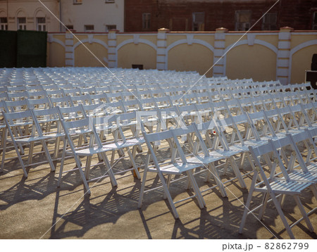 White chairs for concert viewers on the street 82862799