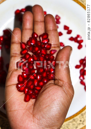 tasty and healthy Pomegranate seeds on hand 82865177