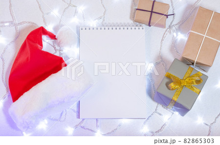 Christmas mockup card with red hat Top view Christmas mockup card with red hat Top view 82865303