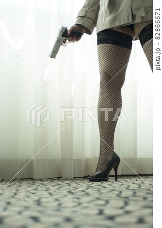 Pistol gun on table in room 82866671