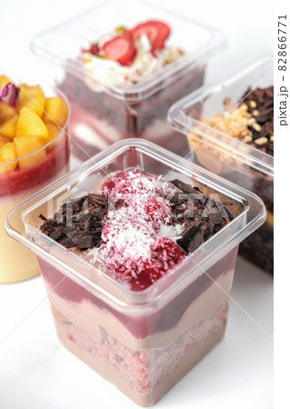 take away trifle cake in a box. chocolate sponge bisquit with mascarpone and cherry berry jam filling. coconut and grated chocolate topping. autumn season sweet treats take away trifle cake in a box. chocolate sponge bisquit with mascarpone and cherry berry jam filling. coconut and grated chocolate topping. autumn season sweet treats 82866771