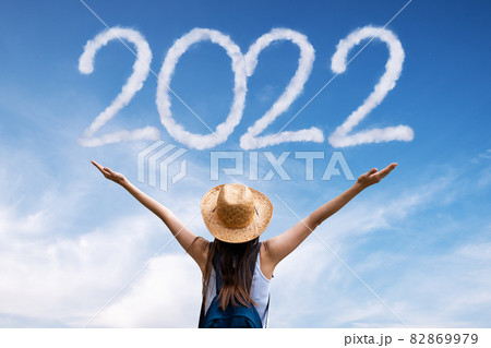Beautiful woman greets the 2020 against clouds 82869979