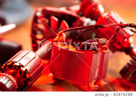 Burnt wires on the parts of an electrical appliance, drills on a wooden table in a repair shop. Power tool repair Burnt wires on the parts of an electrical appliance, drills on a wooden table in a repair shop. Power tool repair 82870288
