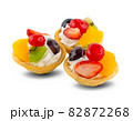 fruit and berry tart dessert with toss sugar on wooden background. Fresh delicious sweet cake with raspberries, grapes, strawberries, cherry, kiwi, grapefruit and cream. 82872268