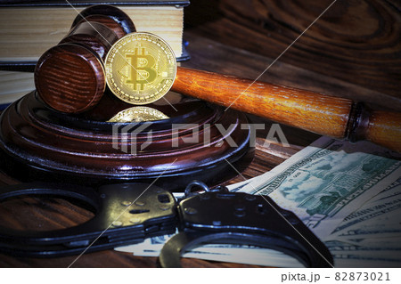bitcoin, judge's hammer, handcuffs. Concept bitcoin ban, violation of the law. 82873021