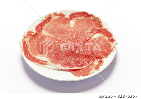 Thin sliced raw beef to prepare for Shabu on white background. Thin sliced raw beef to prepare for Shabu on white background. 82876367