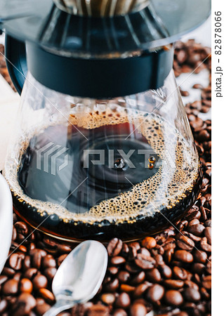 Fresh brewed coffee in a cup using Alternative method, with pour over dripper and paper filter. 82878066