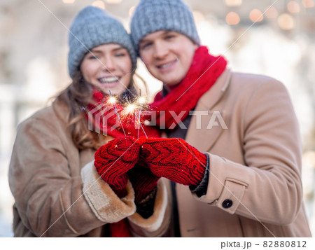 Young dates with bengal lights celebrating winter holidays 82880812