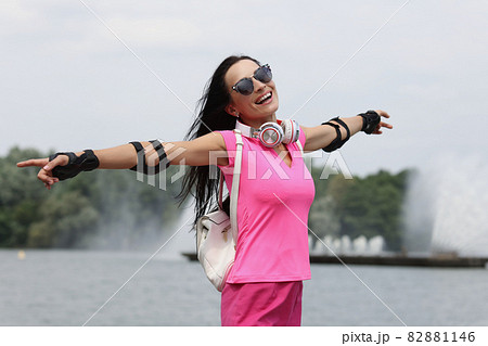 Portrait of happy smiling woman in sunglasses on background of fountain Portrait of happy smiling woman in sunglasses on background of fountain 82881146