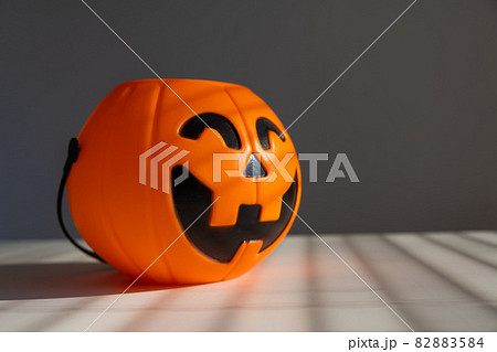 A basket for sweets in the shape of a pumpkin jack on a lantern on a white background. 82883584