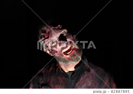 Zombie male makeup for halloween concept. Blood on skin face 82887895