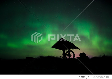 Aurora in the starry sky above the well 82890216