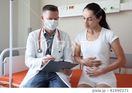 Doctor conducts medical examination of female patient in clinic Doctor conducts medical examination of female patient in clinic 82890371
