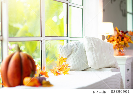 Window sill with blanket. Autumn home decoration. 82890901