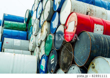 Old chemical barrels with flammable liquid warning label . Steel oil tank. Toxic waste in metal tank. Hazardous chemical barrel. Hazard waste storage in factory. Chemical barrels stack. Oil brent. Old chemical barrels with flammable liquid warning label . Steel oil tank. Toxic waste in metal tank. Hazardous chemical barrel. Hazard waste storage in factory. Chemical barrels stack. Oil brent. 82891111