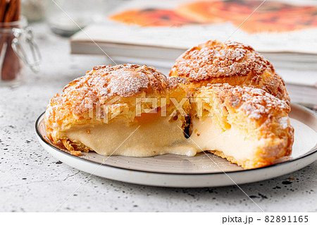 Fresh baked choux pastry cakes with cream Fresh baked choux pastry cakes with cream 82891165