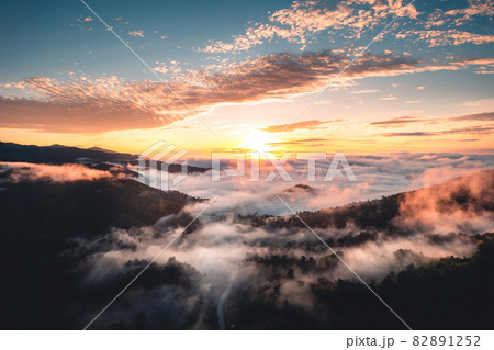 The sun rises in the mist and mountains in the morning The sun rises in the mist and mountains in the morning 82891252