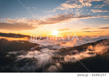 The sun rises in the mist and mountains in the morning 82891257