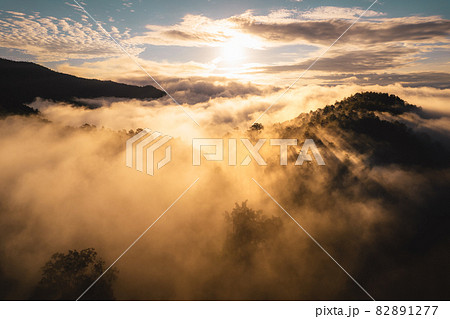 The sun rises in the mist and mountains in the morning The sun rises in the mist and mountains in the morning 82891277