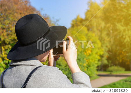 Woman tourist in hat, backpack taking photo. 82891320