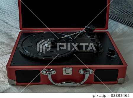 Portable turntable on white bed. Portable turntable on white bed. 82892462
